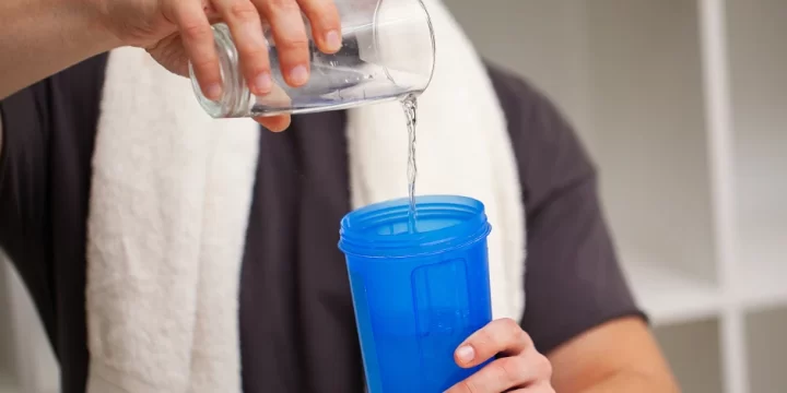 Pouring water inside his tumbler
